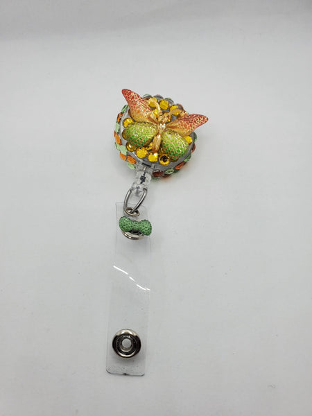Orange , green and gold butterfly badge reel